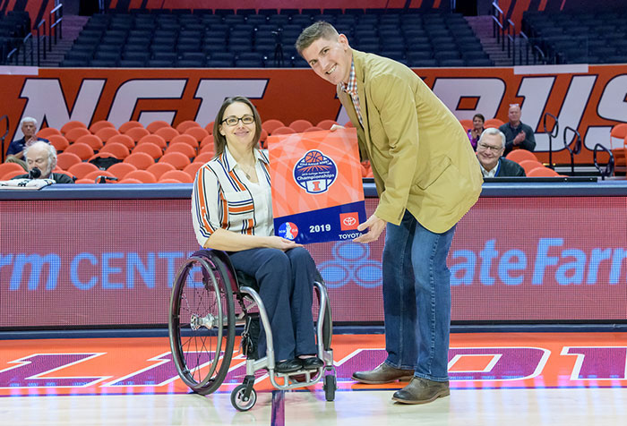 Stephanie Wheeler in wheelchair getting award