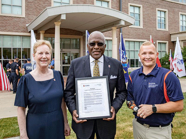 AHS Dean Dr. Cheryl Hanley-Maxwell, U of I Chancellor Robert Jones, and Chez Veterans Center outreach coordinator and student recruiter Garret Anderson pose with ceremonial plaque outside the Chez Veterans Center