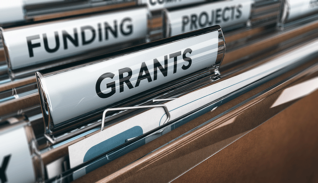 files in filing cabinet labeled Grants, Funding, and Projects