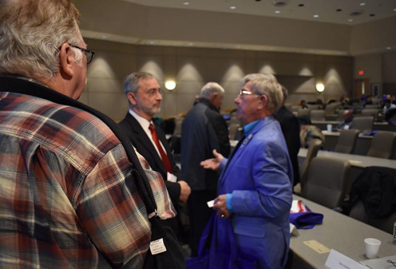 Dr. James Kelly speaks to a veteran during the TBI conference