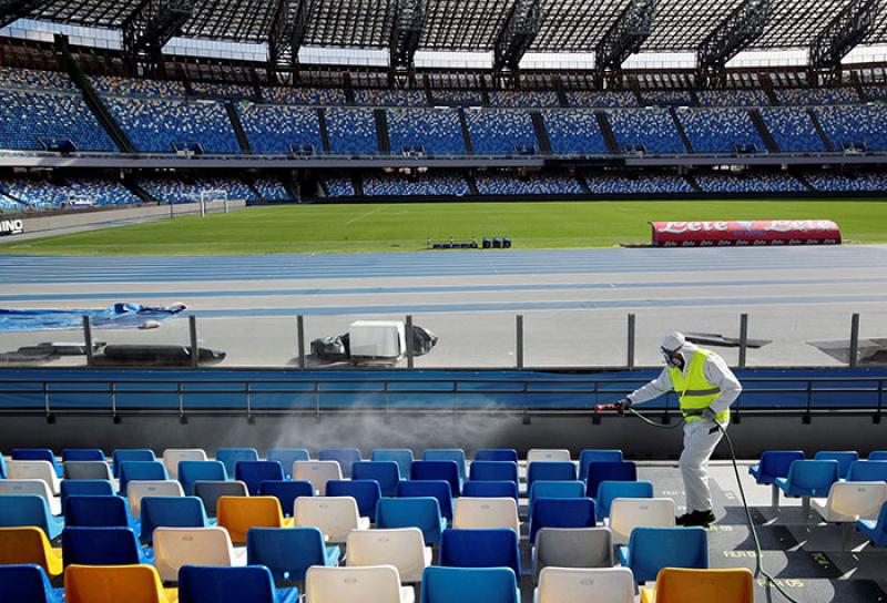 Worker clears debris from empty stadium